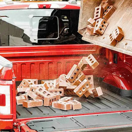 Red pick up truck with a load of bricks